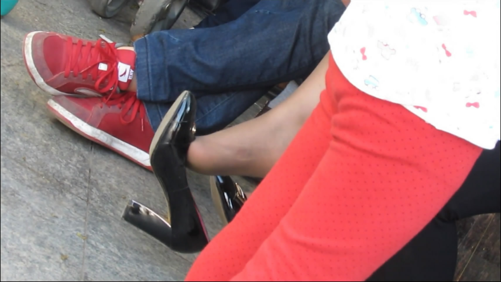 Black high heels and red sneakers